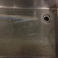 a stainless steel sink with a hole in it