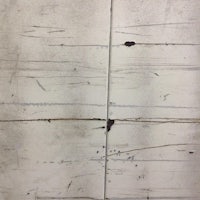 a close up of a white wall with paint on it